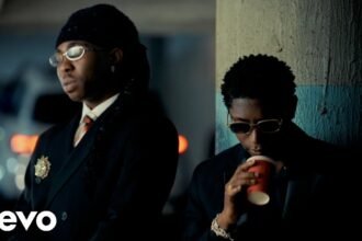 FOLA performing alongside Bella Shmurda and Zlatan in the official music video for it's over.