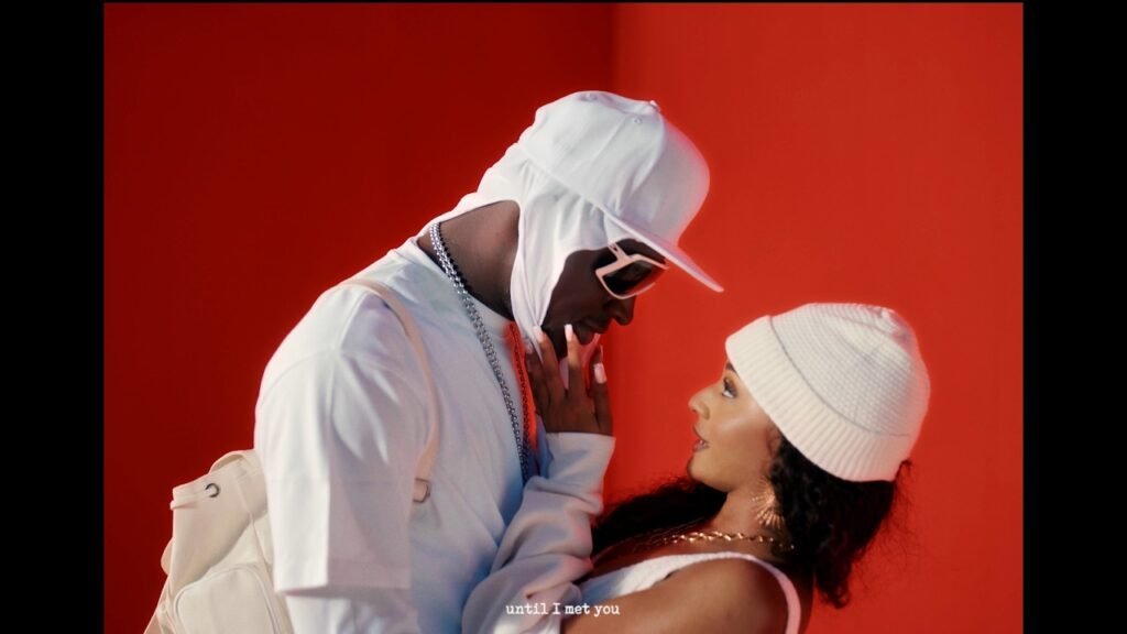 Taylor Jasmine and Carter Efe standing together in front of a colorful backdrop during the ‘Met You’ video shoot, representing the connection between Atlanta and Lagos.
